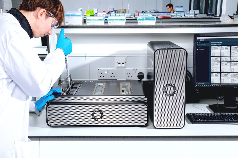 Researcher pipetting sample into PromethION 24 device