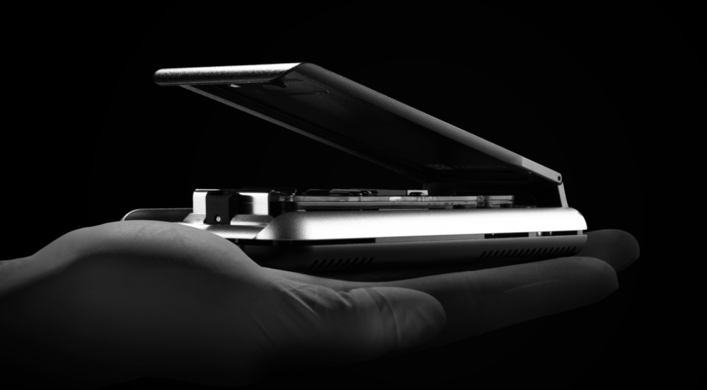 MinION Mk1D in palm of hand on dark background