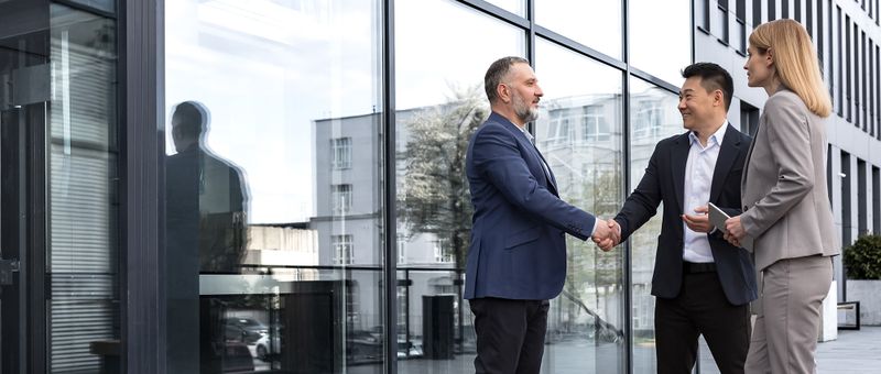 Business partners meeting and shaking hands