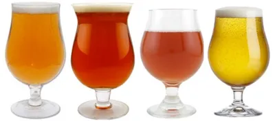four glasses containing orange red or yellow liquid