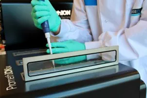 Scientist loading PromethION device at BaseClear