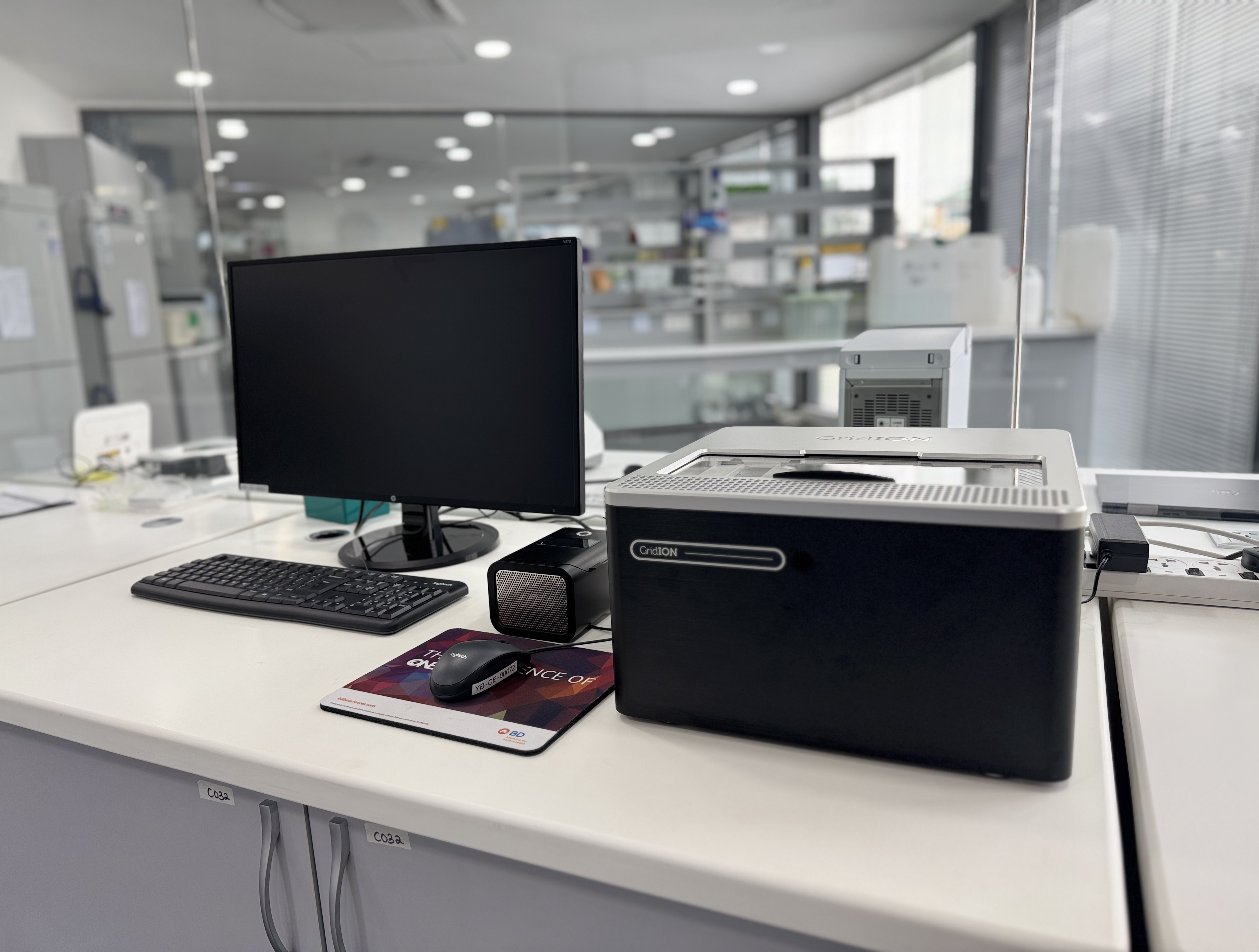 Image of a gridION, a P2, and computer screen in a white lab