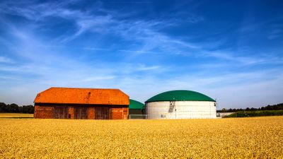 Biogas plant and barn in field