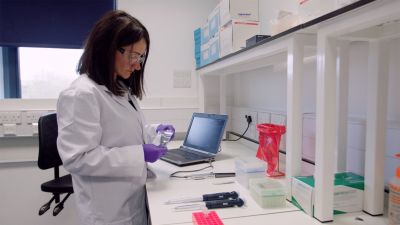 photograph of a girl working at a lab bench