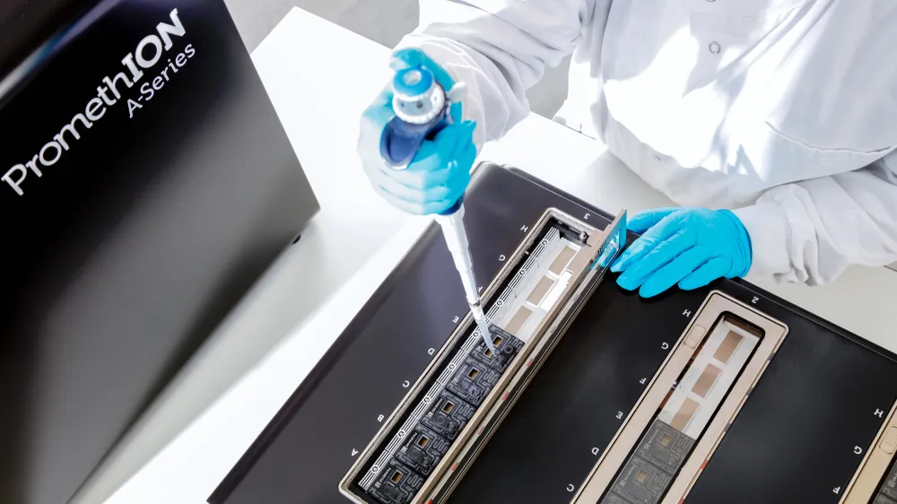A scientist loading a flow cell in a PromethION
