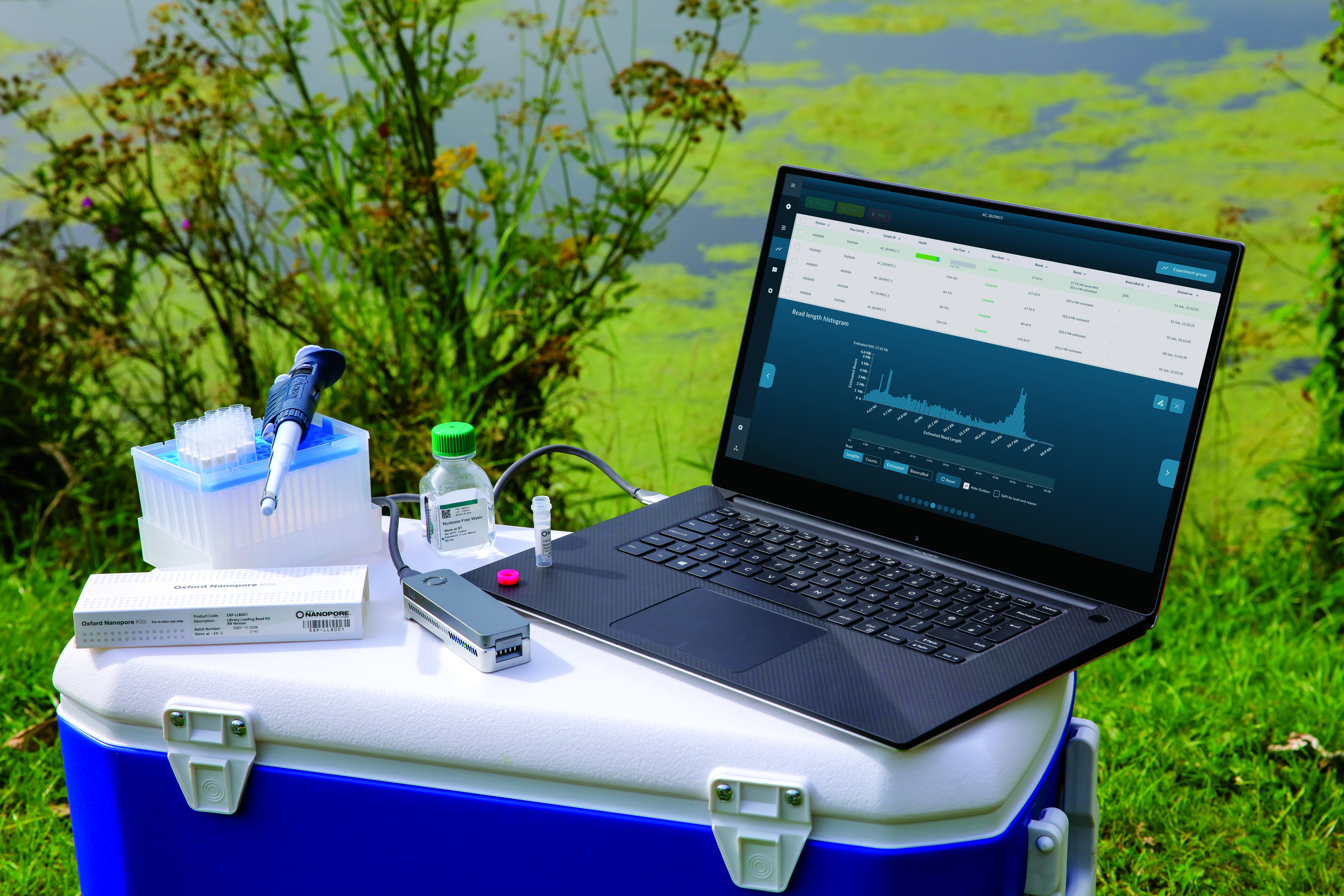 MinION, laptop and sequencing consumables on top of a cooler in a field