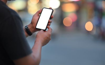 photograph of man holding a mobile phone
