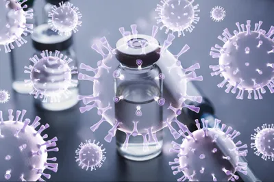 vial of viral vaccine overlaid with artist impressions of virus particles