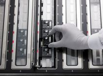 A PromethION Flow Cell being loaded on to a PromethION 48 device