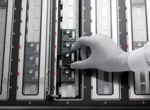 A PromethION Flow Cell being loaded on to a PromethION 48 device