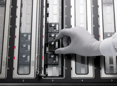 A PromethION Flow Cell being loaded on to a PromethION 48 device