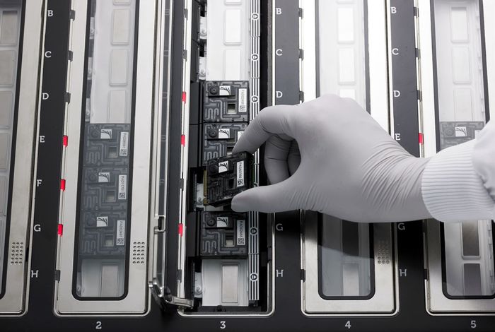 A PromethION Flow Cell being loaded on to a PromethION 48 device