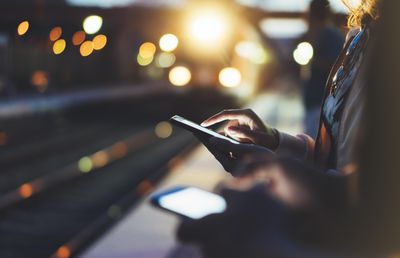 woman holding smartphone in hand