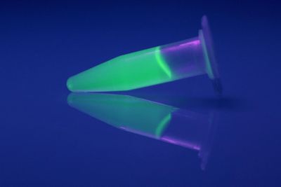 eppendorf tube containing fluorescent green liquid
