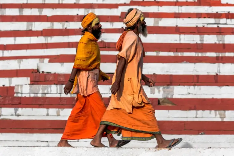 Two men wearing orange traditional clothing