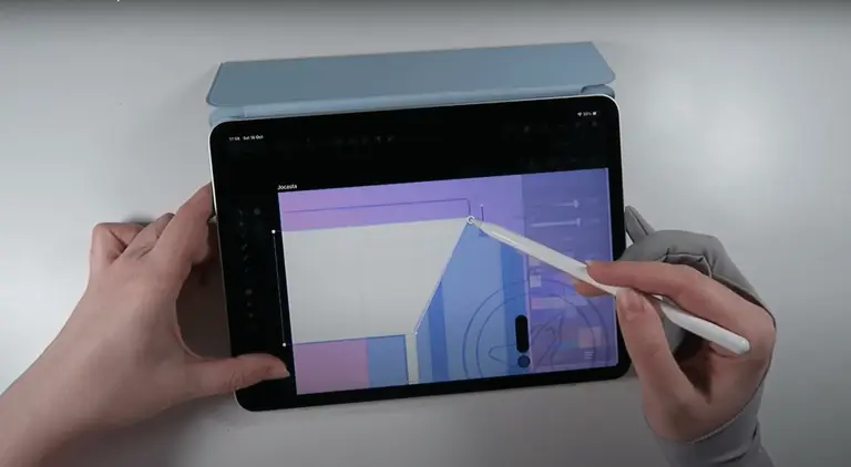Hands using a stylus on a tablet