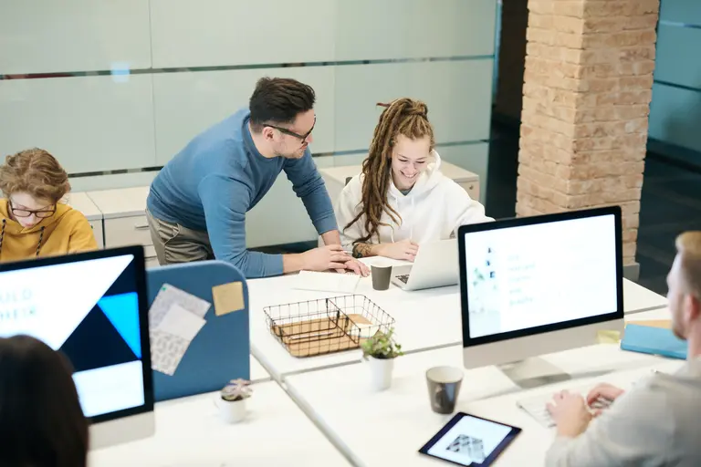 People discussing work in an office setting