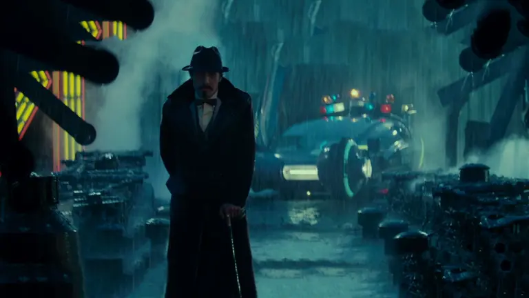 Man walking in the rain in a futuristic cityscape
