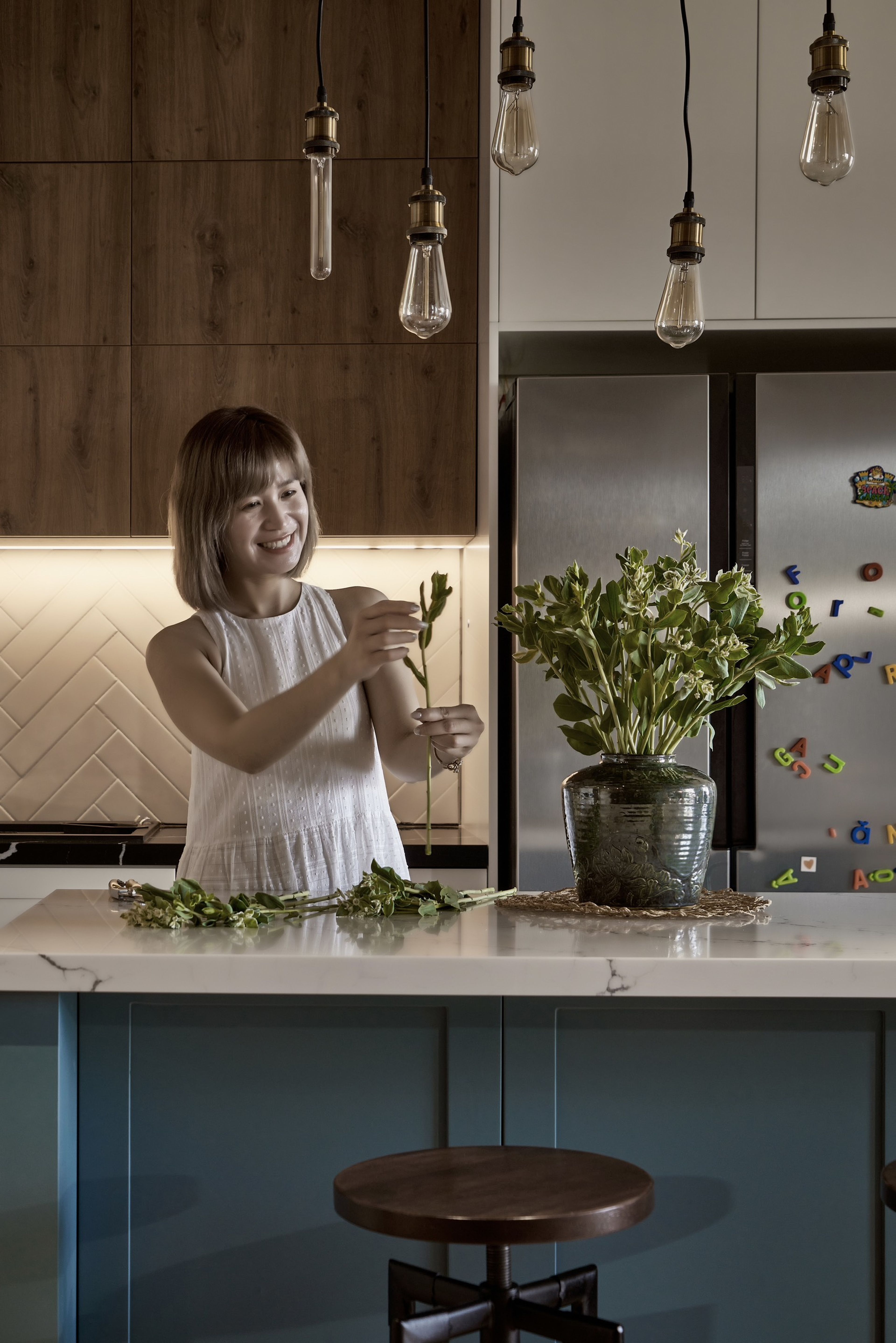 The lady enjoys time in her lovely kitchen
