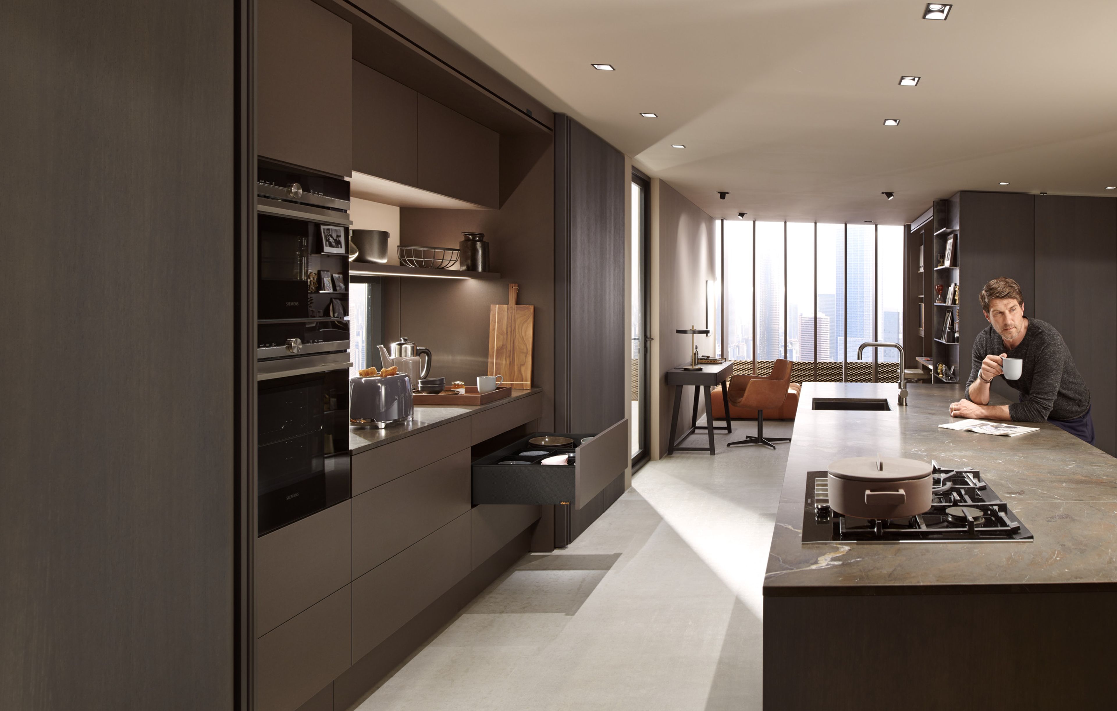 An open SPACE TOWER larder unit with several LEGRABOX drawers in a dark kitchen