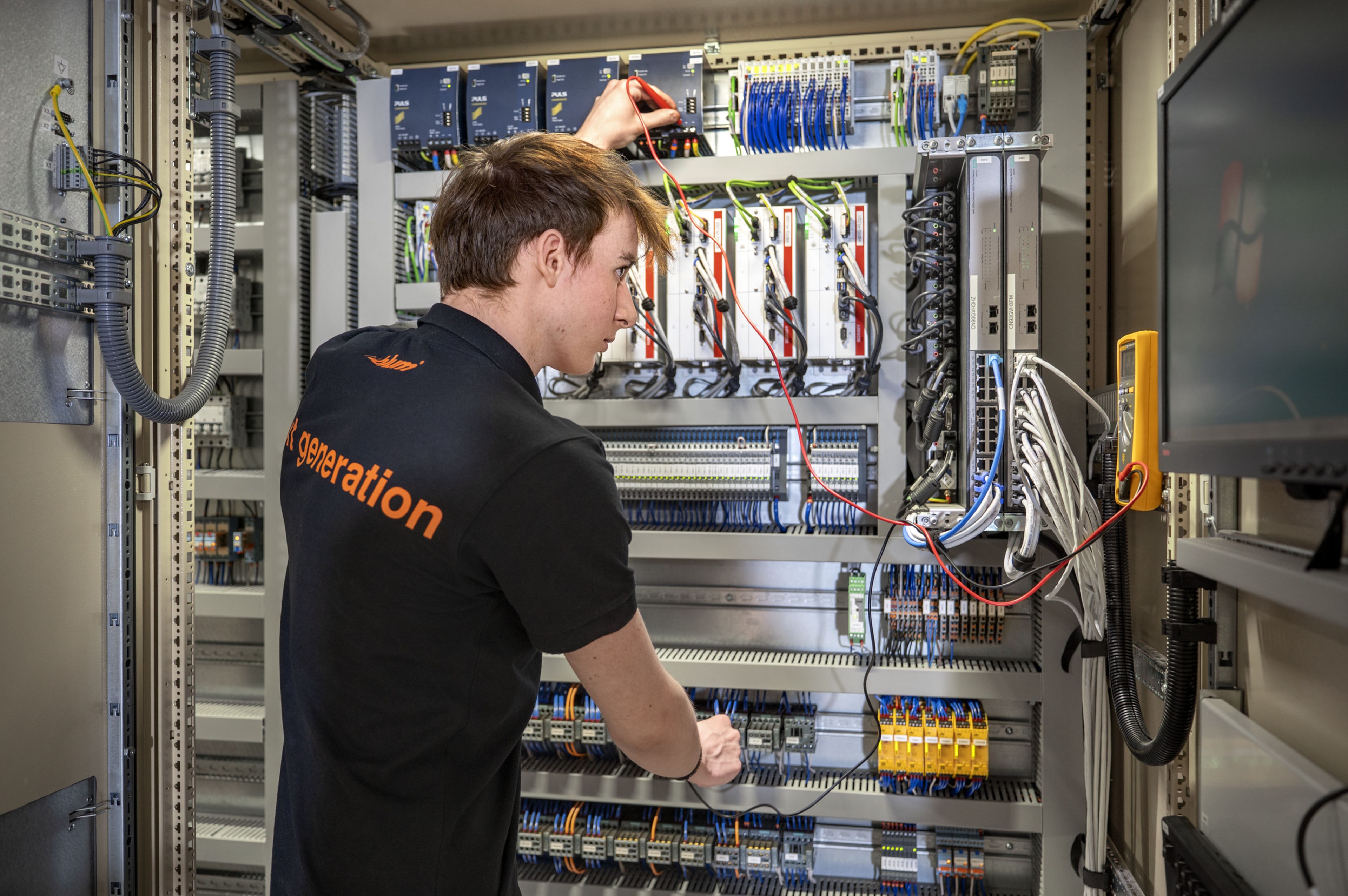 Das Bild zeigt einen Dualen Akademikern bei Blum am Lernen im Bereich Elektrotechnik