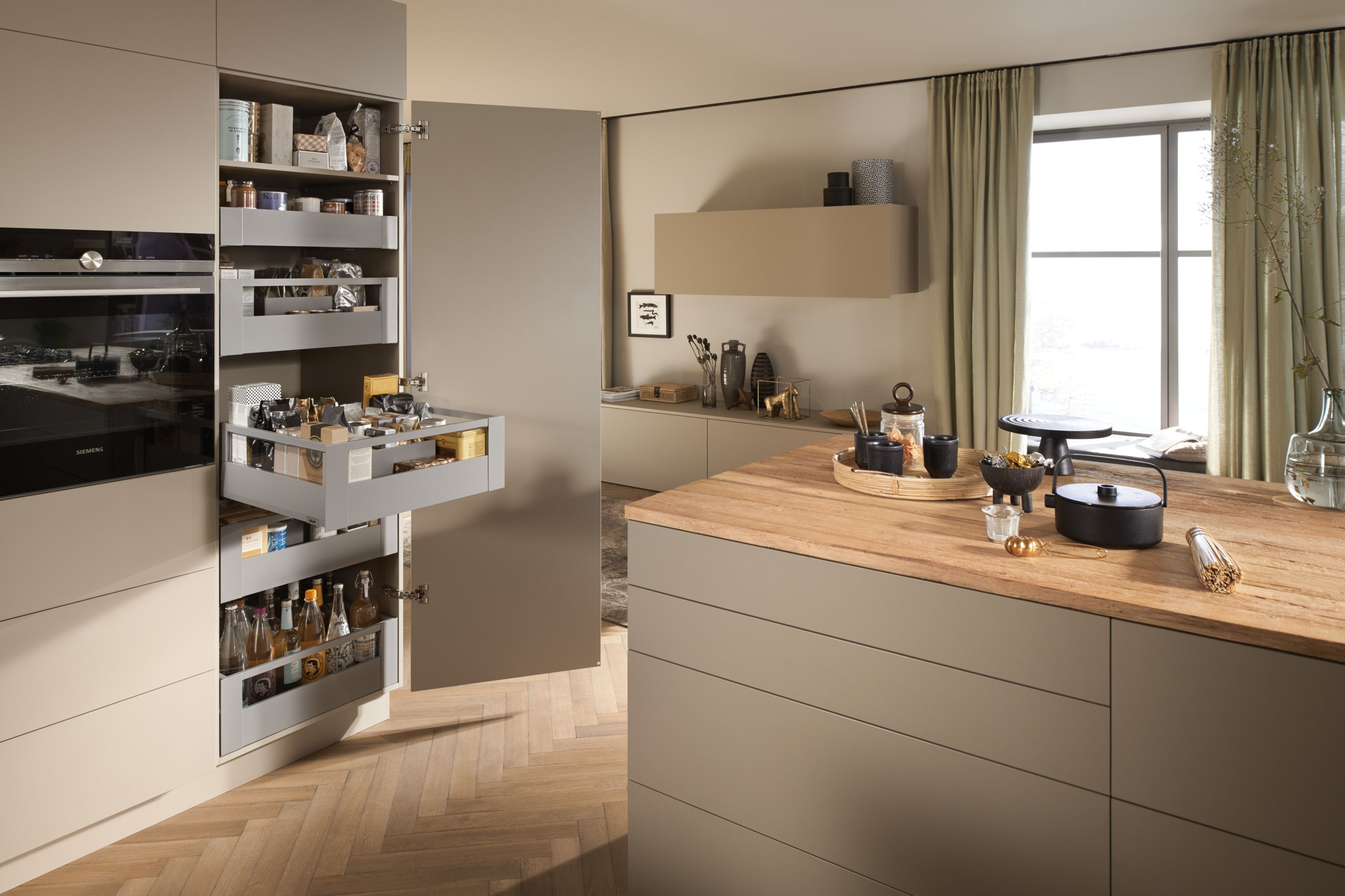 A SPACE TOWER pantry with drawers filled with food items in a compact kitchen