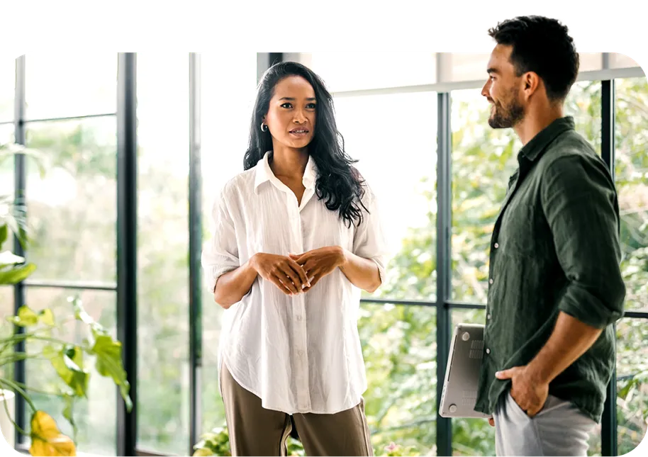 Two colleagues talking in a bright office