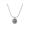Silver pendant necklace featuring a round medallion with an engraved, abstract design, hanging from a delicate chain.