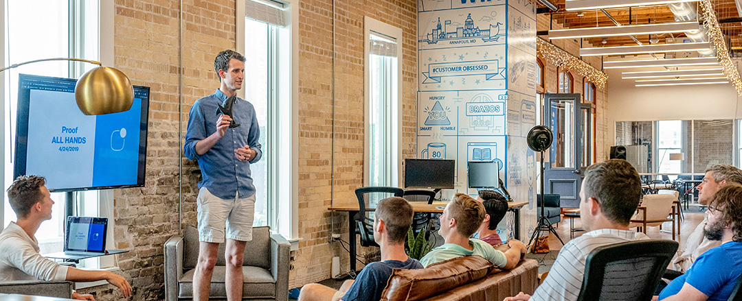 Speaker presenting company updates to employees during an internal business meeting