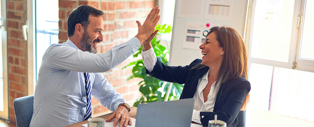 Leadership success Business leaders celebrating success in a structured hybrid work model