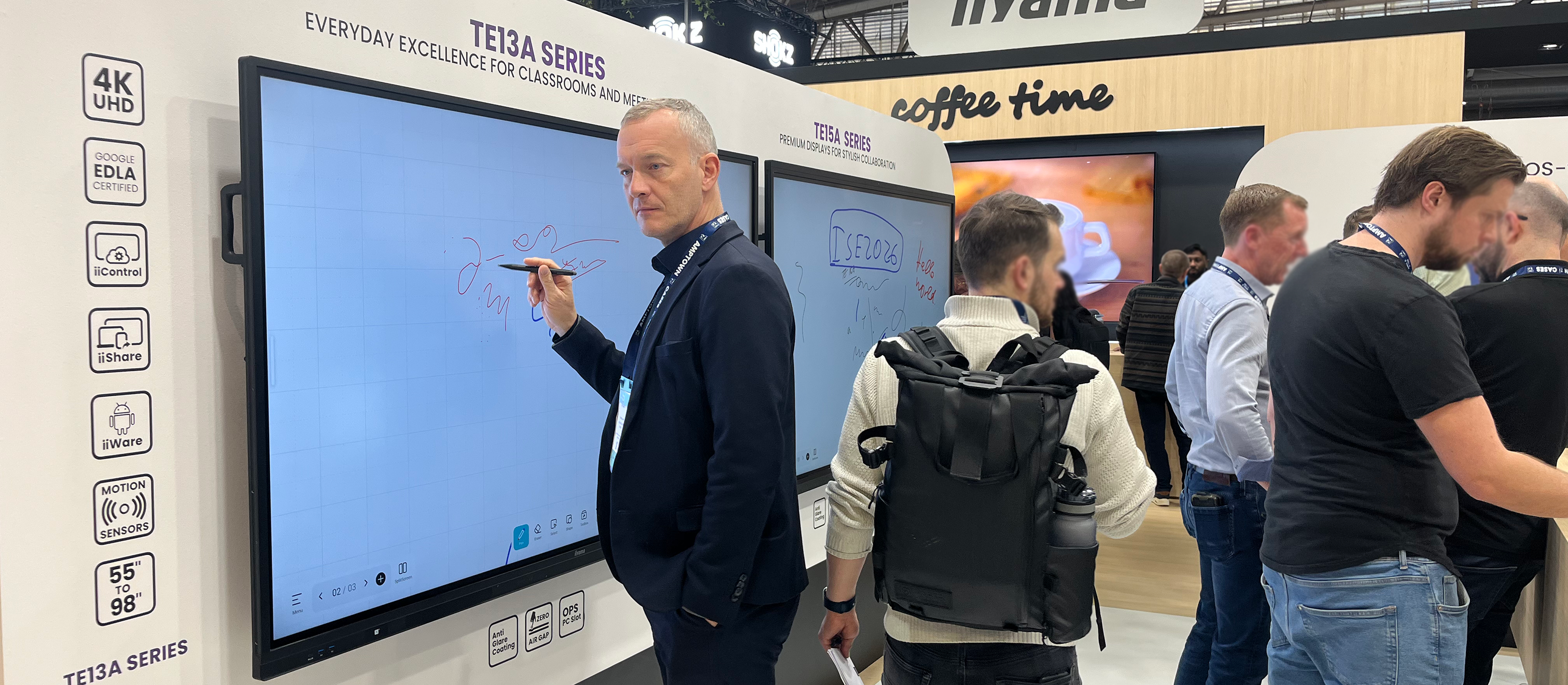 Professional writing on a large 4K interactive display from the TE13A Series during a product presentation at ISE 2026.