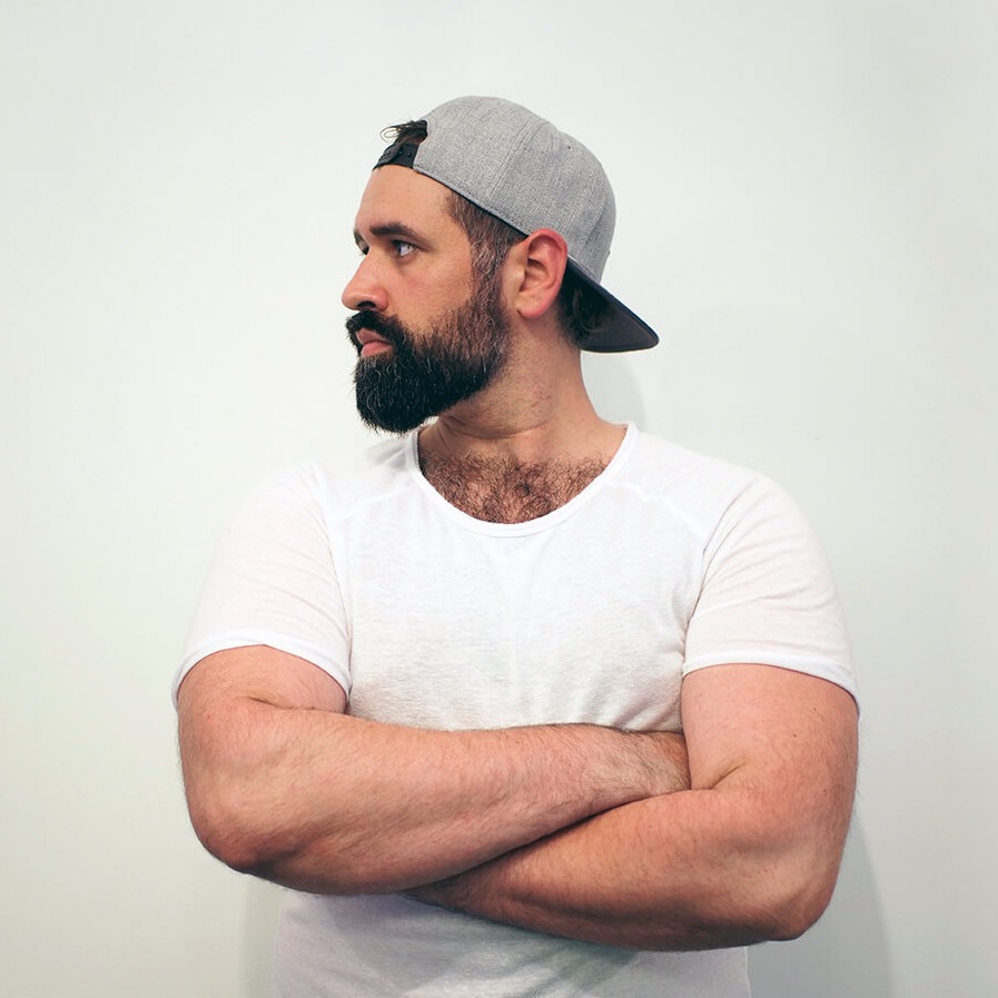 Ali Soueidan standing in front of a wall