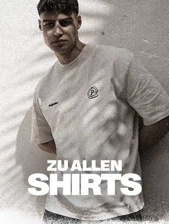 Man in a light-colored t-shirt stands against a textured wall with "Zu Allen Shirts" text overlay at the bottom.