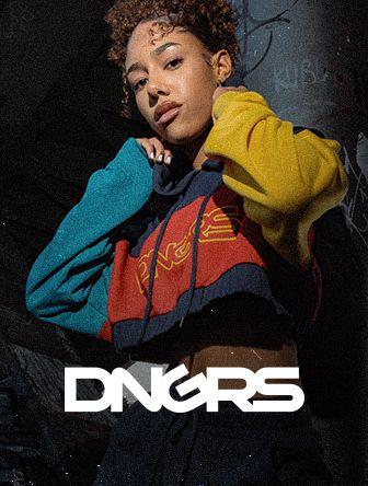 Person poses confidently in a vibrant, multicolor hoodie, with "DNGRS" logo below. Dark, textured background.
