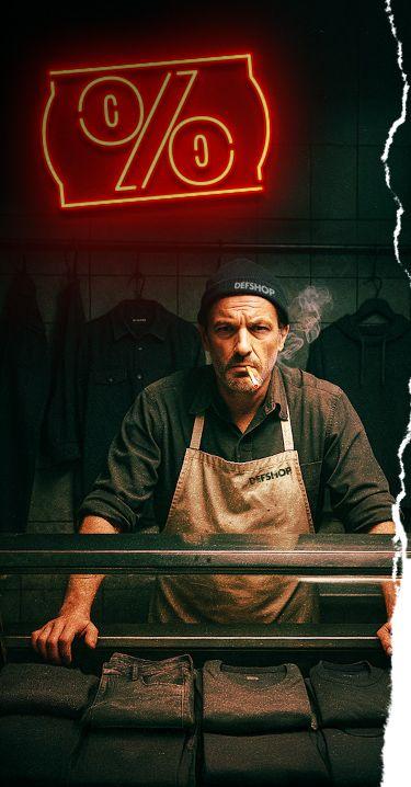 Image of a man behind a counter with a glowing percent sign.
