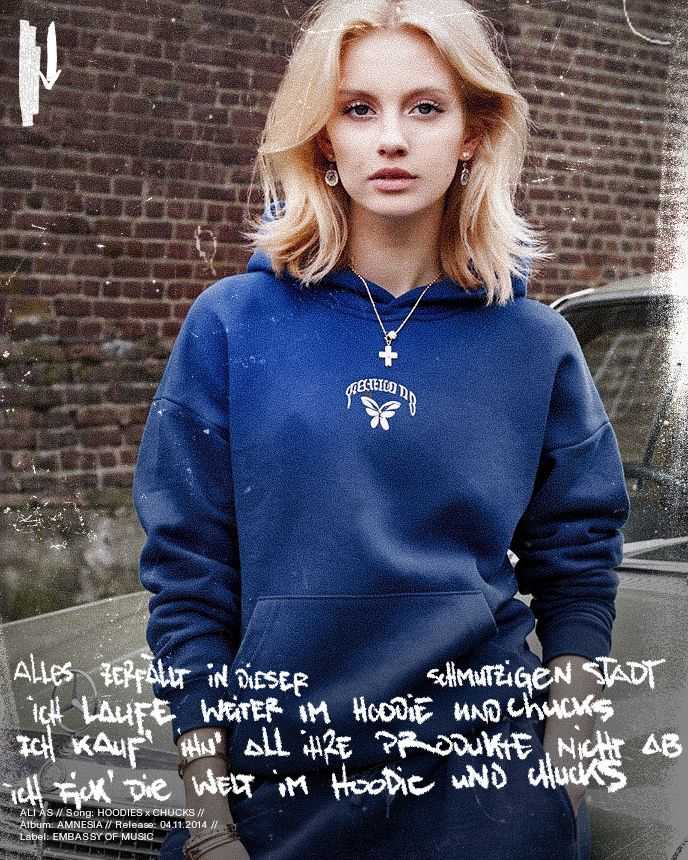 Blonde woman in a blue hoodie stands in front of a brick wall. Handwritten text overlays the image.