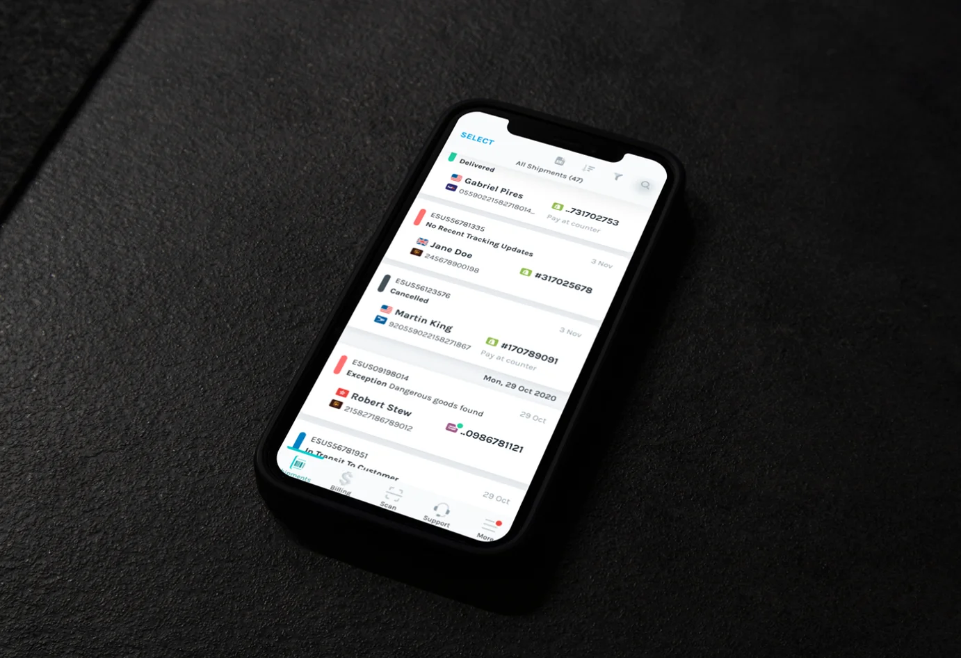 Picture of smartphone on a dark desk with a bright screen that has the Easyship mobile application's package tracking screen on it.