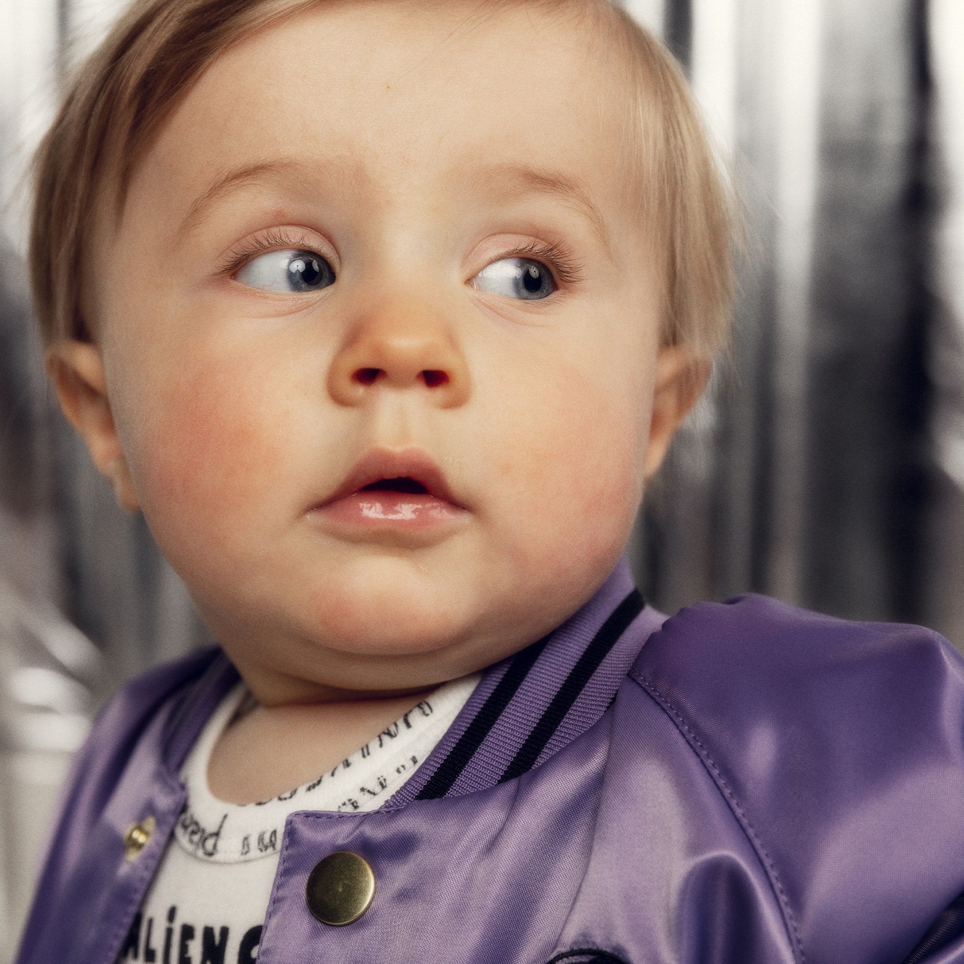 Baby wearing Soccerball chenille satin baseball jacket from Mini Rodini Alien Affairs collection