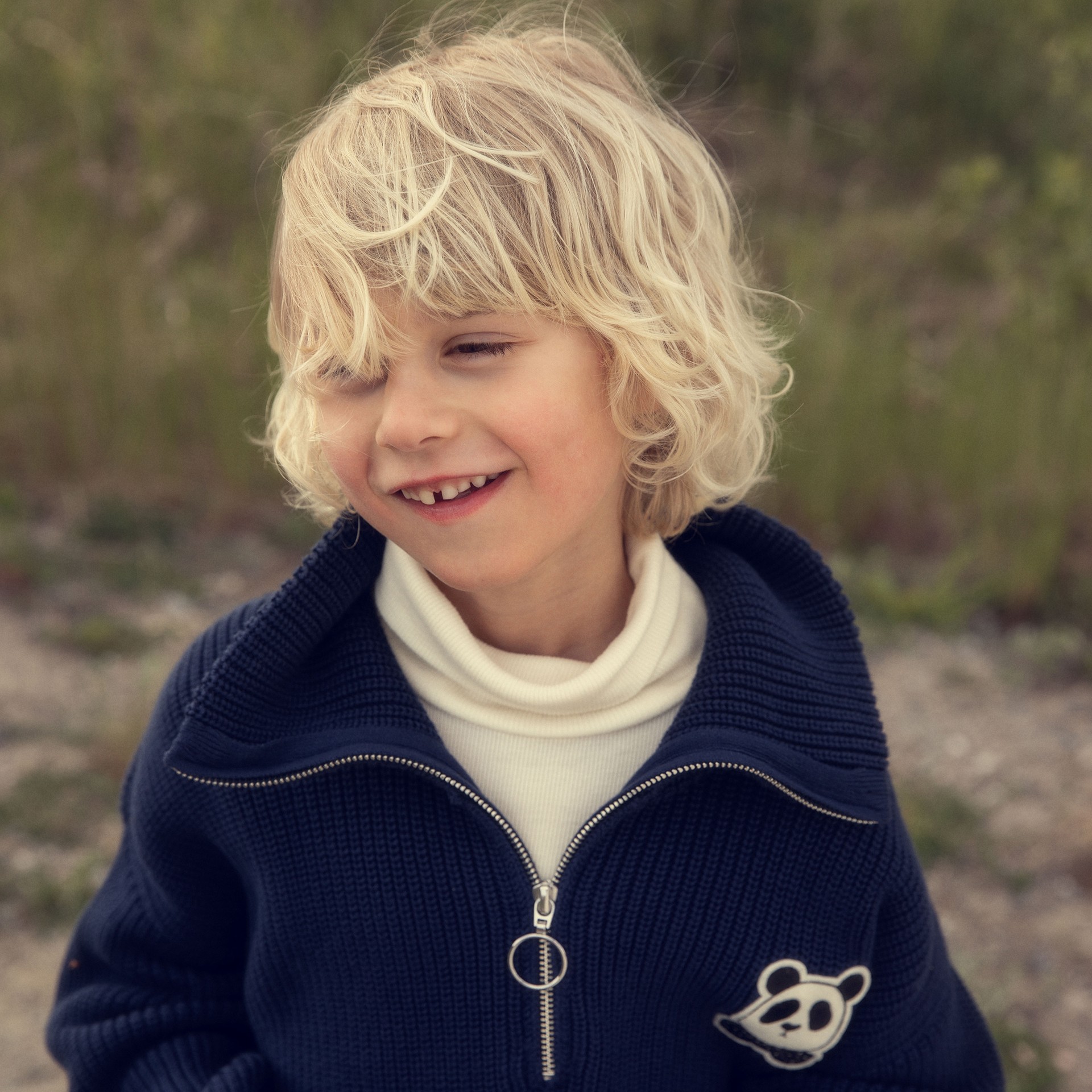 Boy wearing Panda chunky knit sweater from Mini Rodini