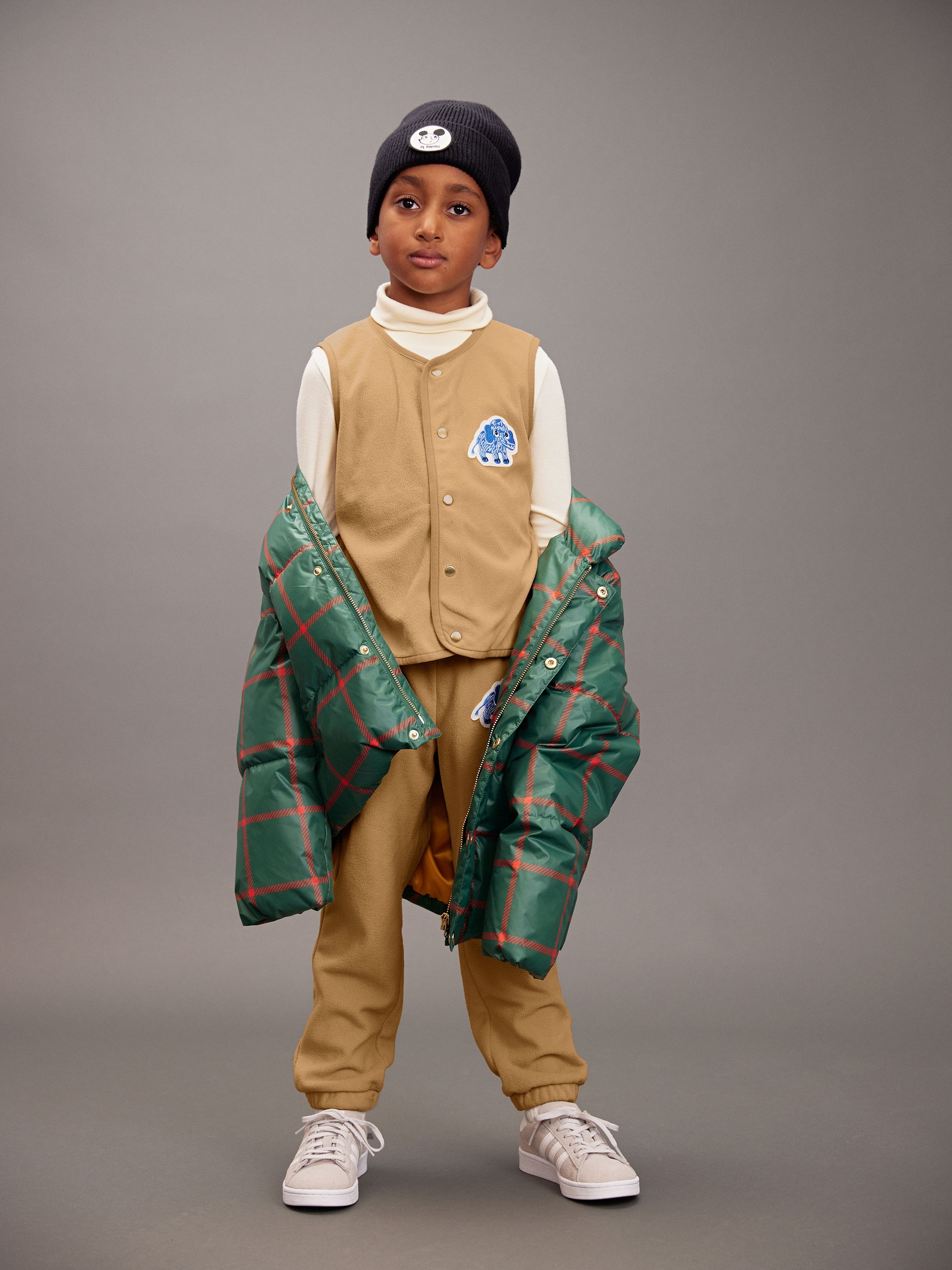Boy wearing Mammoth patch fleece vest and fleece trousers from Mini Rodini Digging deep collection