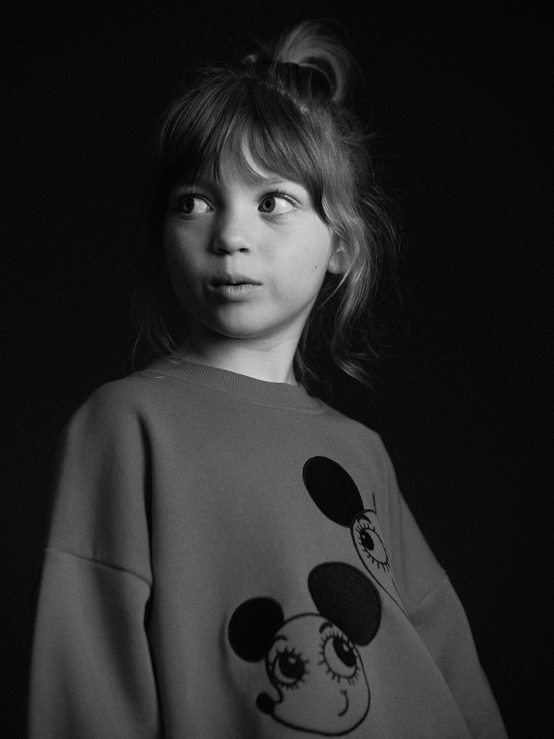Black and white image of a girl wearing ritzratz sweatshirt