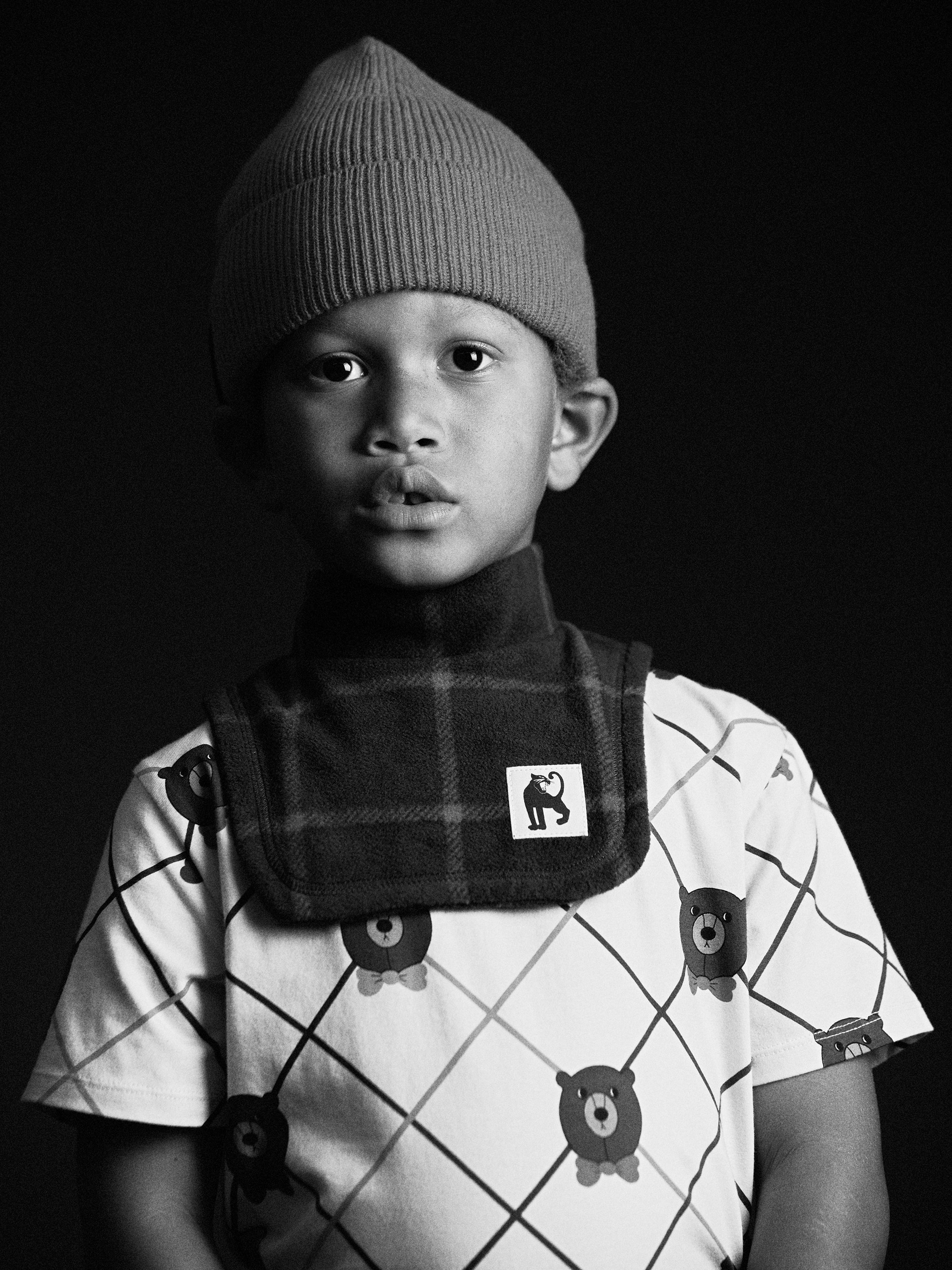 Black and white image of Plaid fleece turtleneck from Mini Rodini digging deep collection