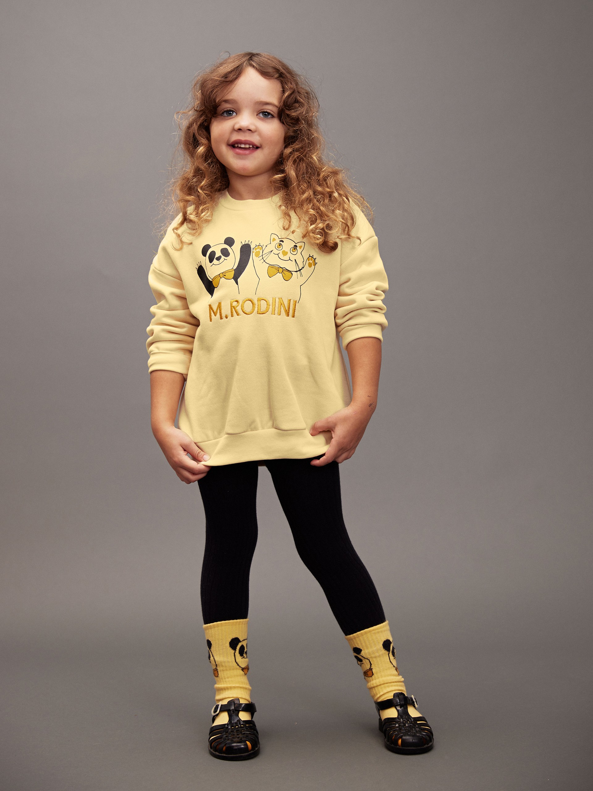 Girl wearing panda & cat sweatshirt in yellow from new collection digging deep Mini Rodini