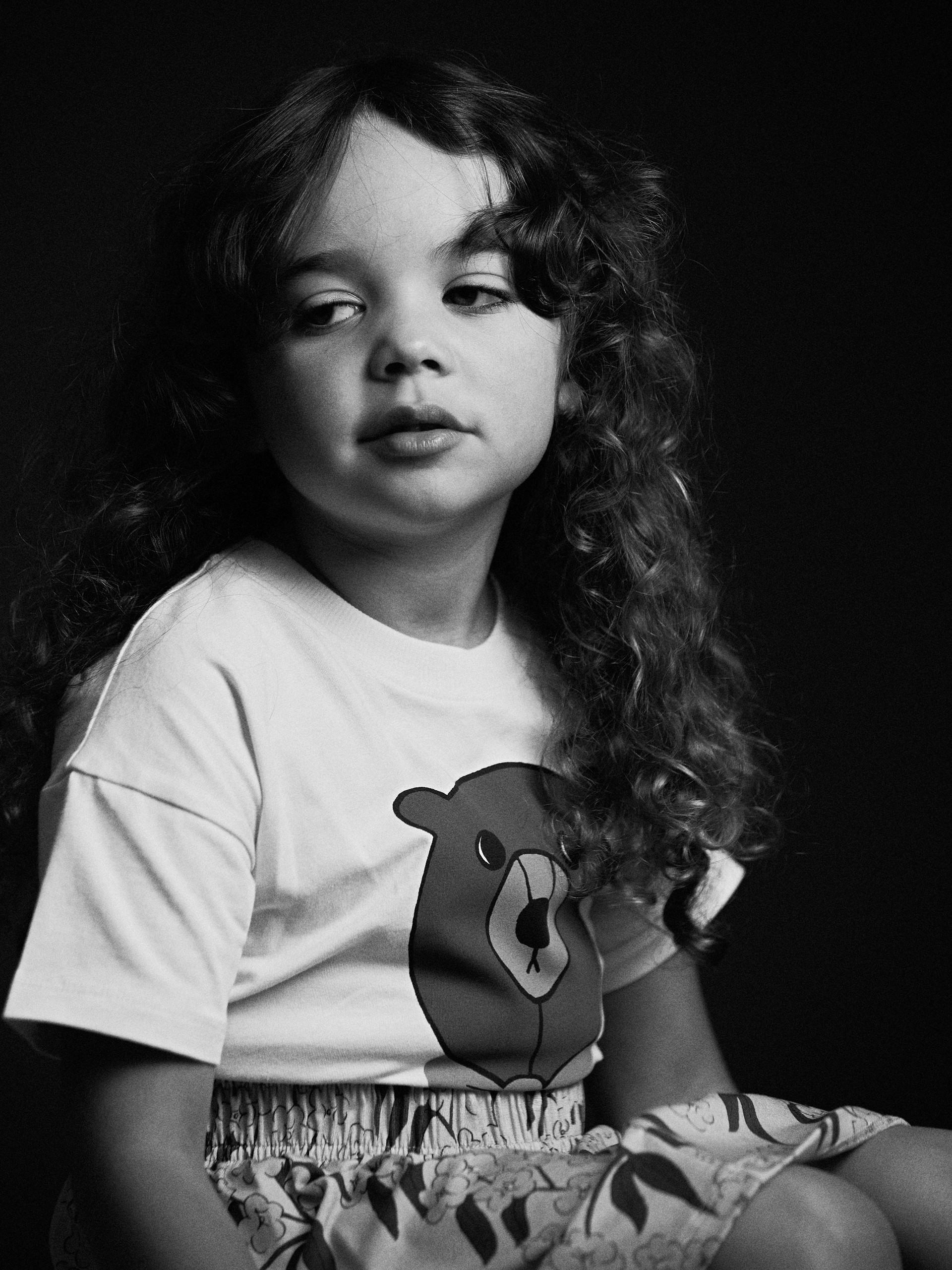 Black and white image of a girl wearing Bear short sleeve T-shirt