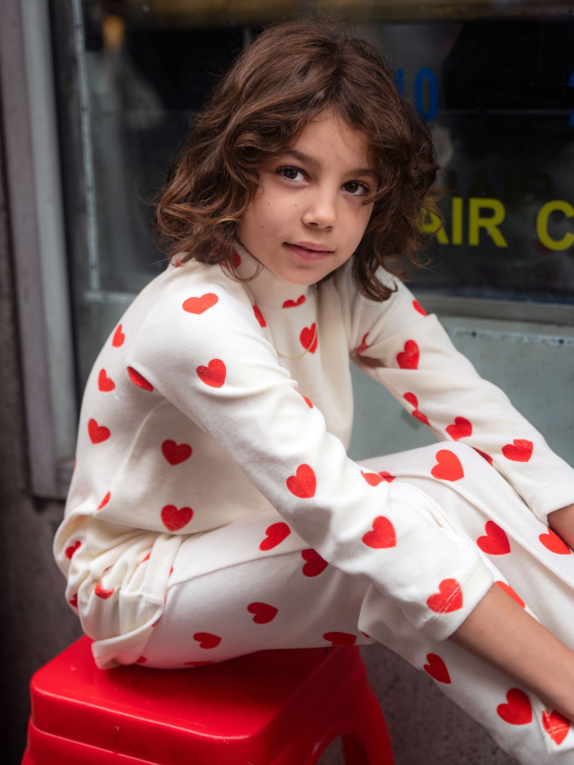 Girl wearing Hearts velour trousers and dress from Mini Rodini Things to love collection