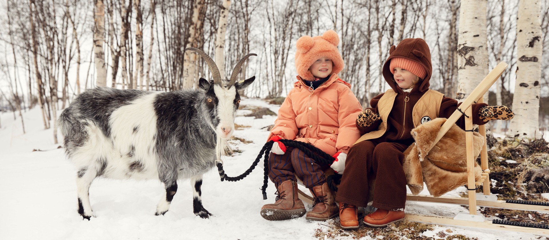 Winter image of girls wearing outerwear from Mini Rodini