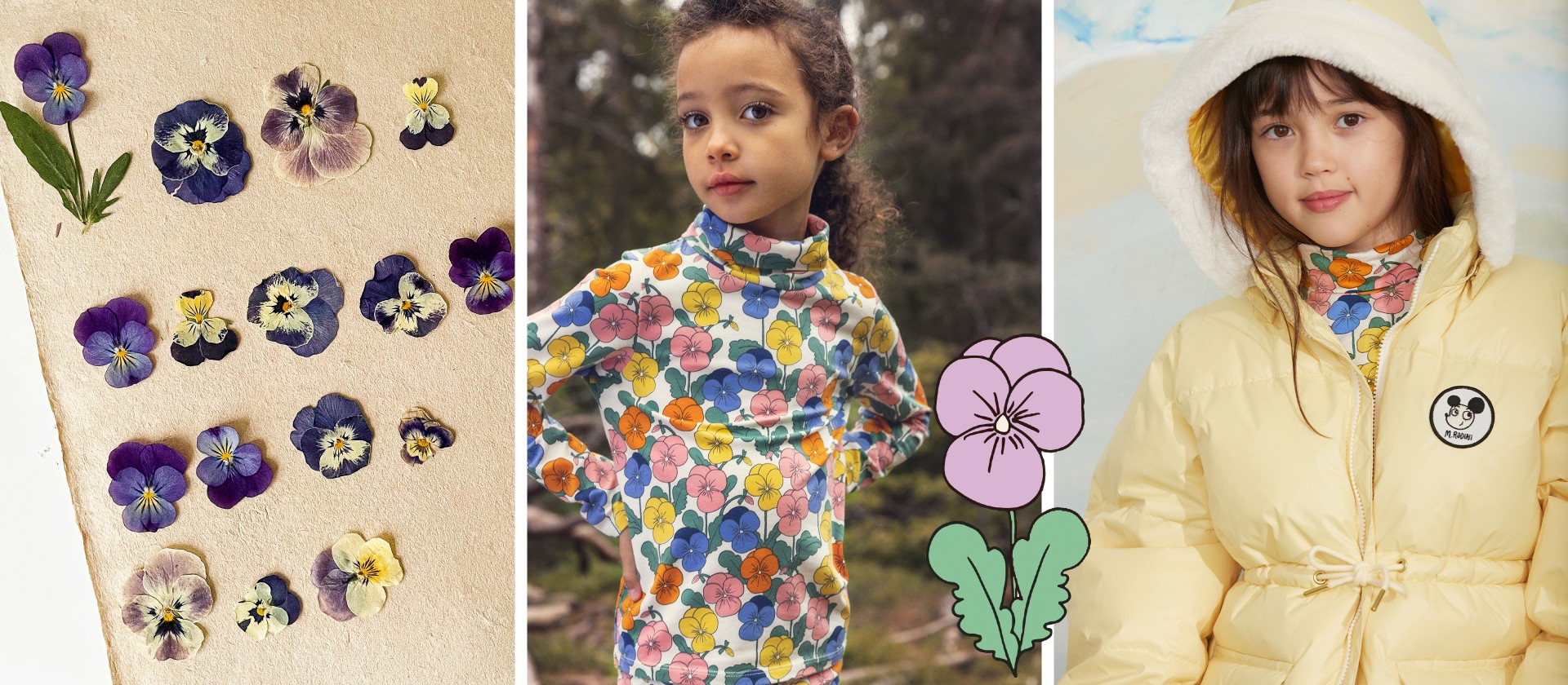 Two children in colorful coats sitting on a log in a forest above a collage of pressed purple flowers on paper.