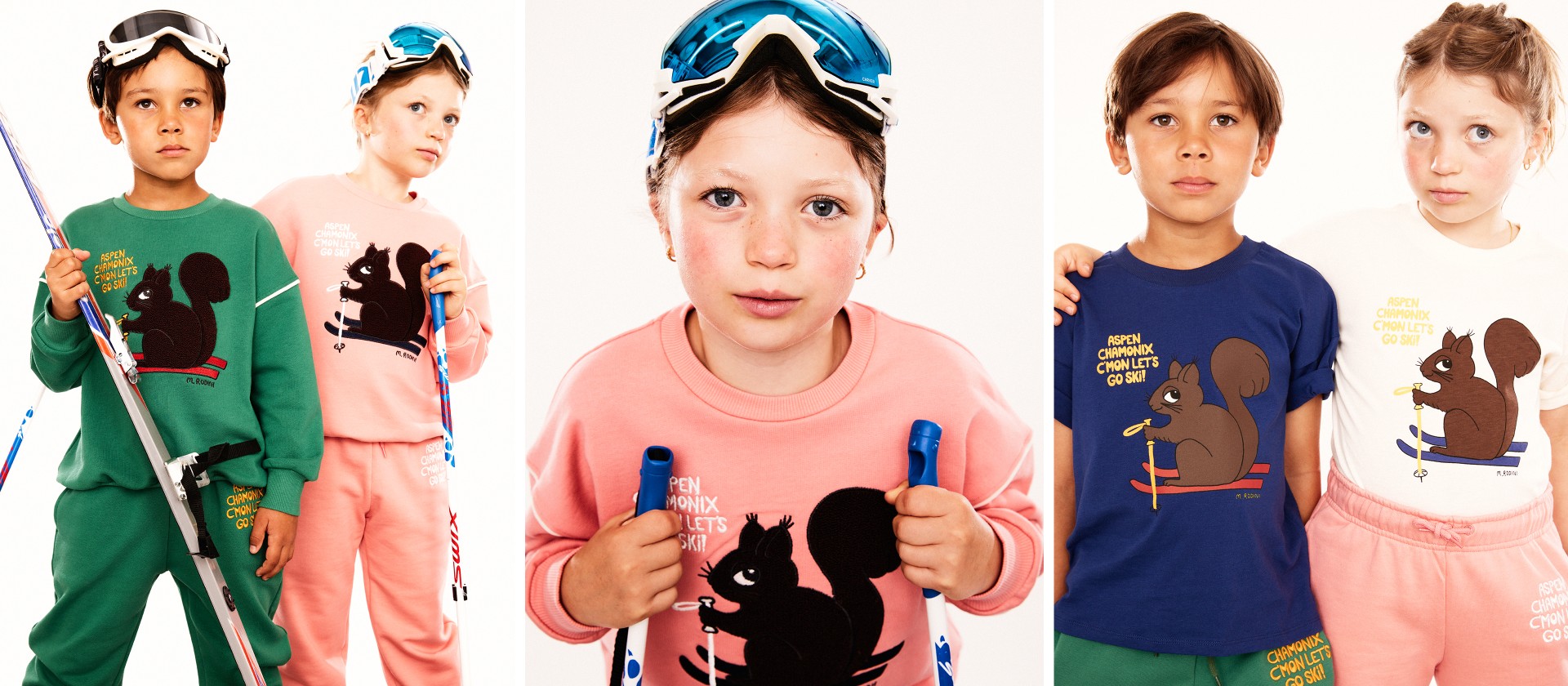 Two children wearing ski goggles and sweaters with black squirrel designs stand together, each holding ski equipment against a white background.