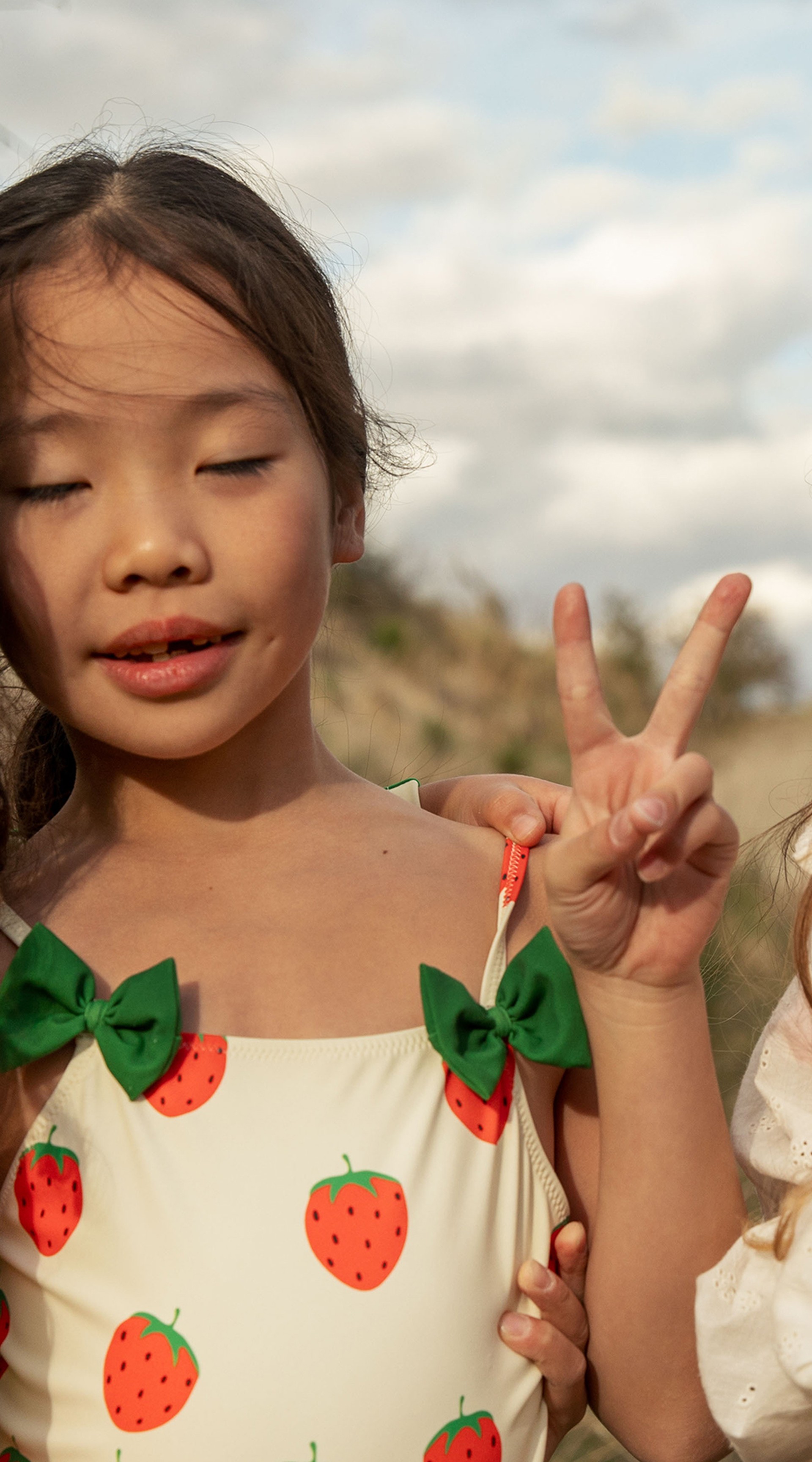 Girls wearing Strawberries print from Mini Rodini