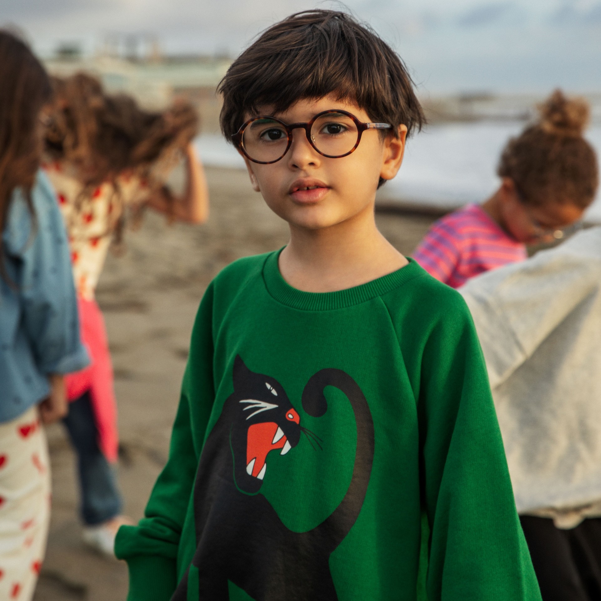 Boy wearing Panther sweatshirt in green from Mini Rodini